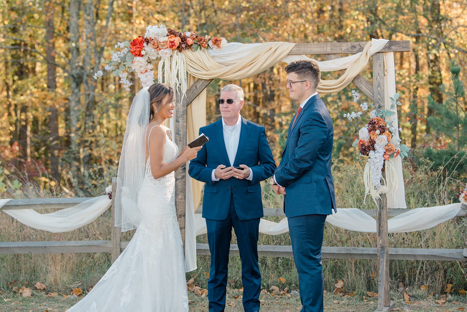 Kalika, myself, and my father standing in front of the arch during the ceremony