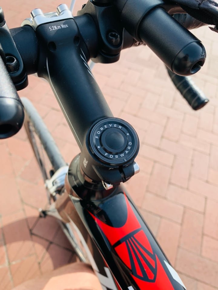 My bike's custom stem cover that says Forever Forward